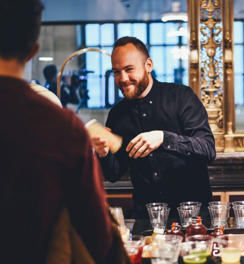 photo of man and woman mixing beverages